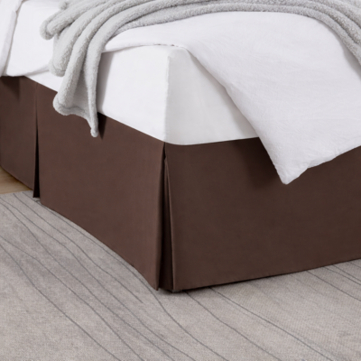 Pleated box bed skirt with 15-inch drop and tailored corners in elegant bedroom setting.