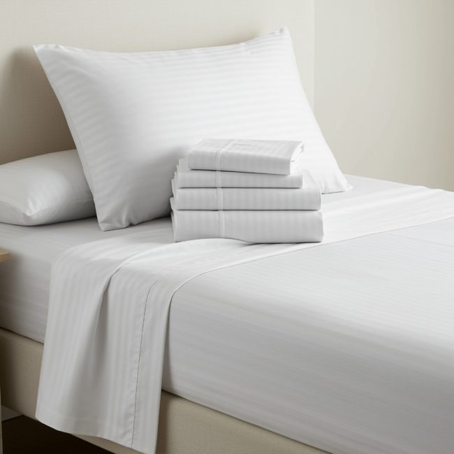 T300 Sateen Stripe Bed Sheets with 1/4” tone-on-tone stripe, made of a soft 70% cotton, 30% polyester blend for luxury and durability.